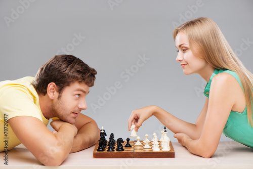 Young couple playing chess