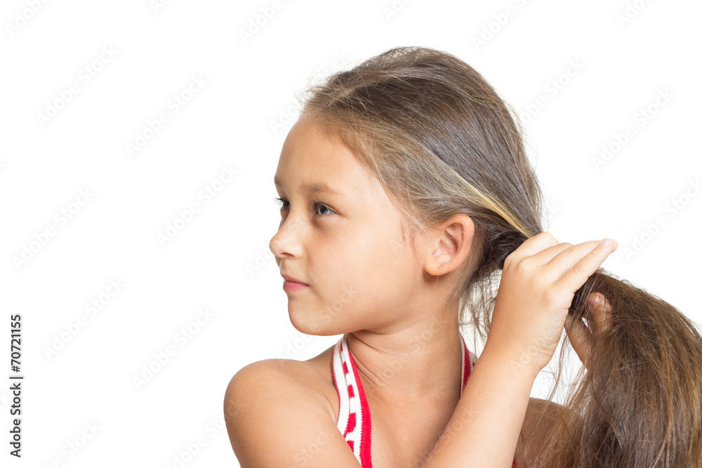 little girl doing hairstyle on a white background little girl doing hairstyle on a white background