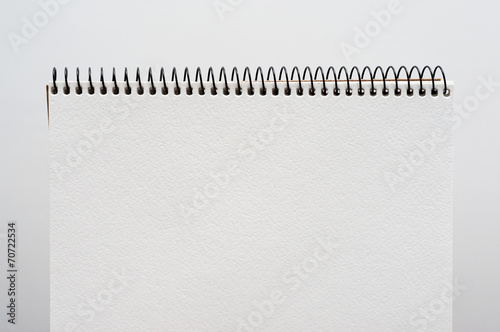 close up of a blank white notebook on white background