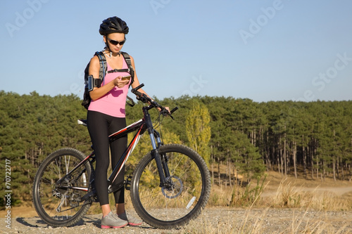 Fototapeta Naklejka Na Ścianę i Meble -  young woman on a bicycle on a tourist trip