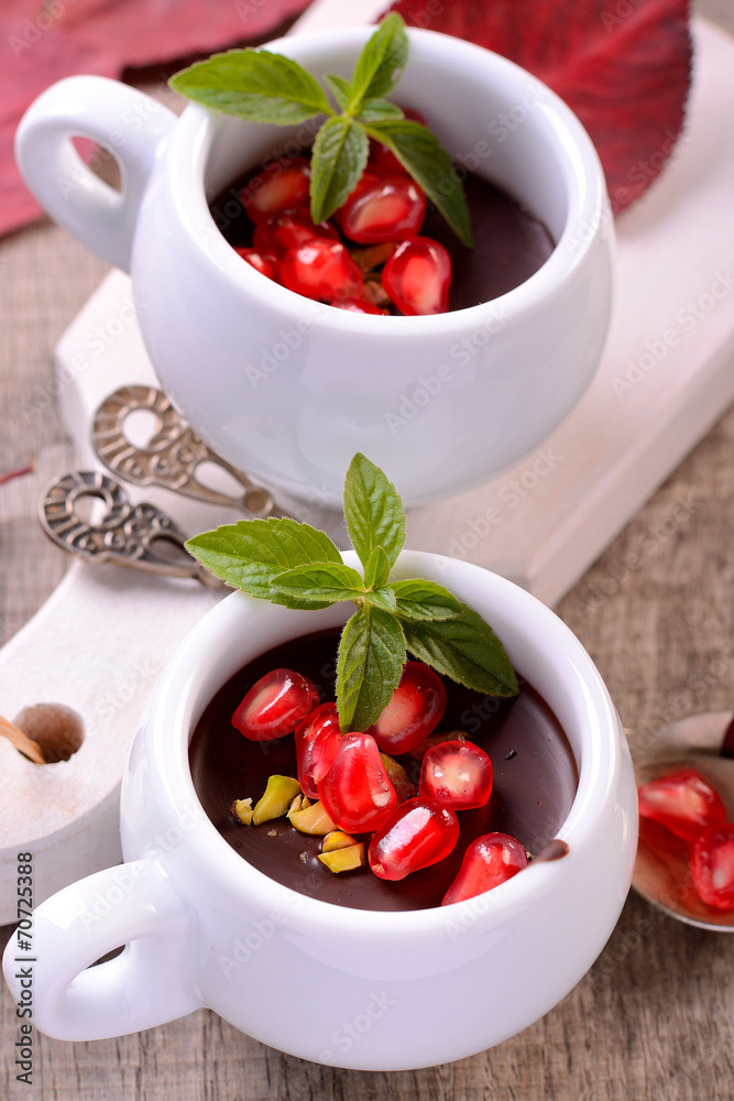 chocolate mousse in a white ceramic cup with pomegranate chocolate mousse in a white ceramic cup with pomegranate