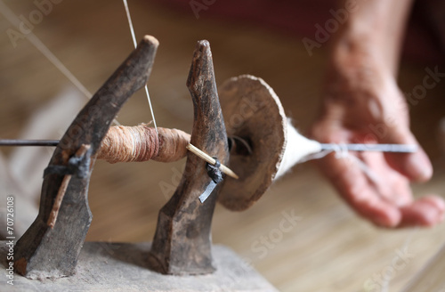 distaff, spinning yarn on an old spinning wheel