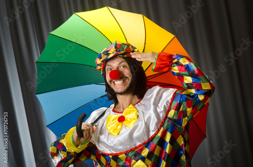 Funny clown with colourful umbrella