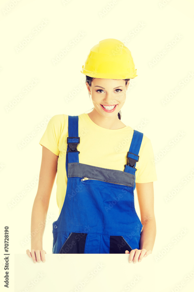 Female construction worker with blank board Female construction worker with blank board