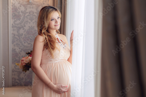 Happy pregnant woman in the room