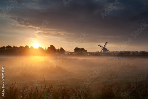 misty sunrise and Dutch windmill