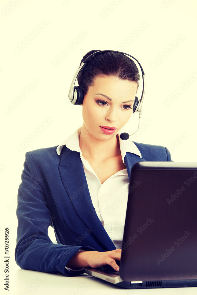 Beautiful young call-center assistant at the desk Beautiful young call-center assistant at the desk