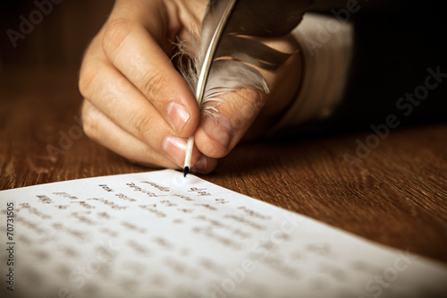 writer writes a fountain pen on paper work photo