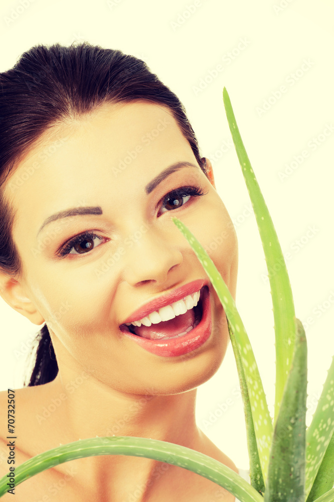 Young beautiful woman's face and aloe vera. Young beautiful woman's face and aloe vera.
