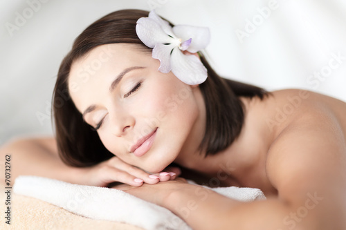 beautiful woman with flower in her hair in spa