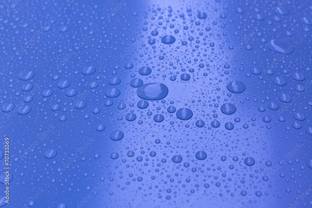 Water drops on bright blue background