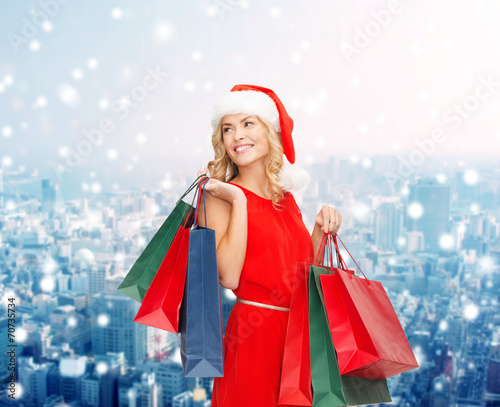 woman in santa helper hat with shopping bags