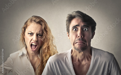Angry woman shouting and fearful man