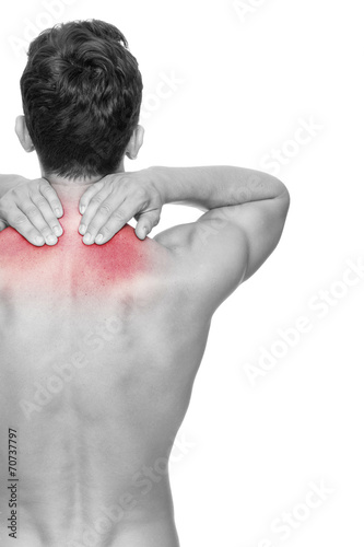 Young man holding his back in pain, isolated on white background