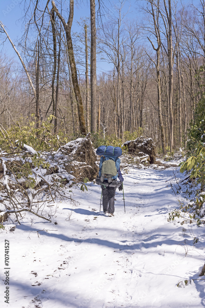 Backpacker on a Snowy Trail after a Spring Snow