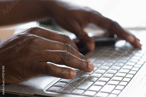 Portrait of an African American typing on the keyboard