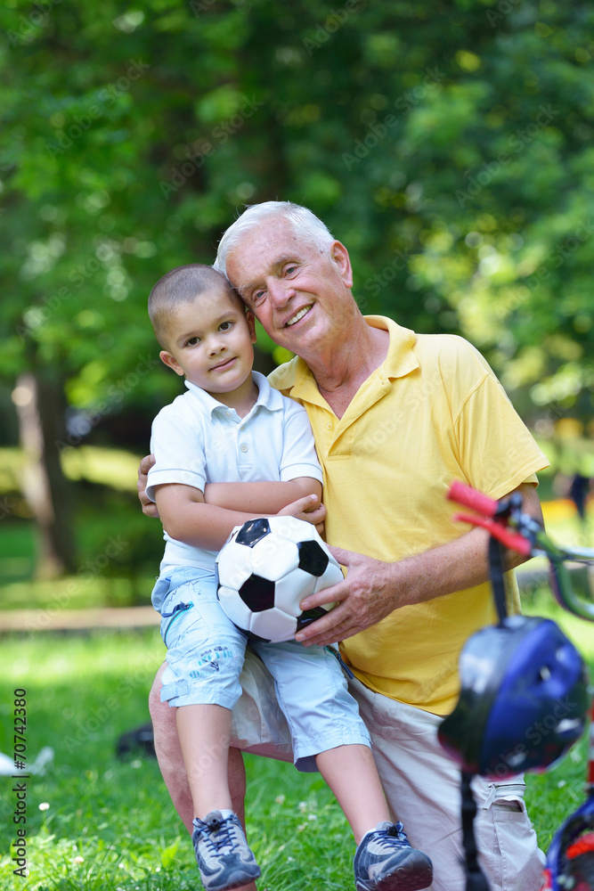 happy grandfather and child in park