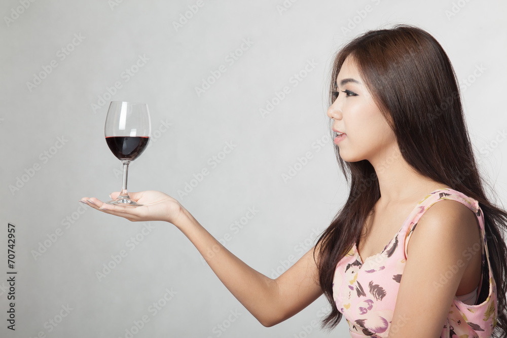 Beautiful Asian woman hold glass of red wine on her palm hand Beautiful Asian woman hold glass of red wine on her palm hand