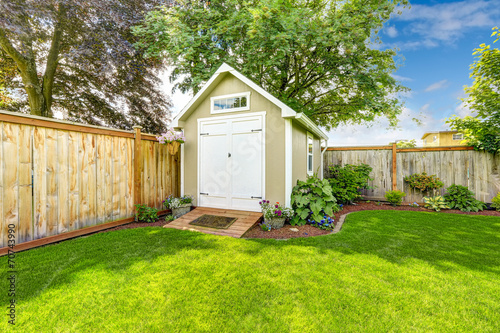 Fenced backyard with small shed