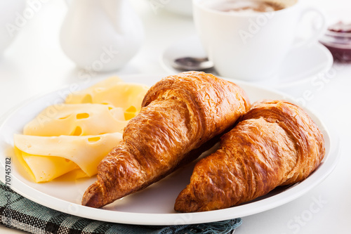 Croissants with cheese  fruits and coffee