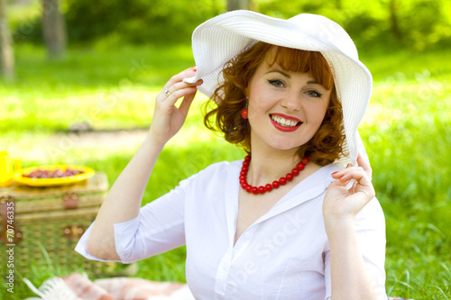 Beautiful stylish young lady in white hat