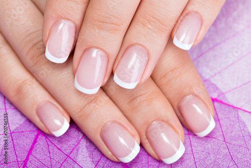 Beautiful woman s nails with french manicure