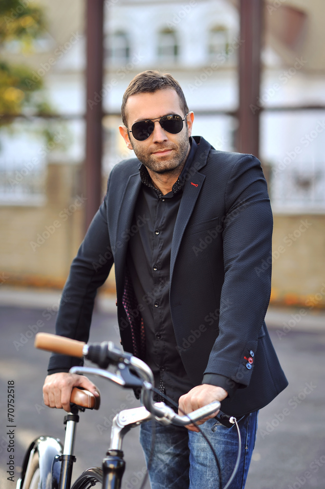 Handsome young man with bike