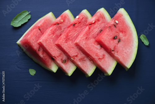 Watermelon slices with fresh mint leaves, above view, close-up