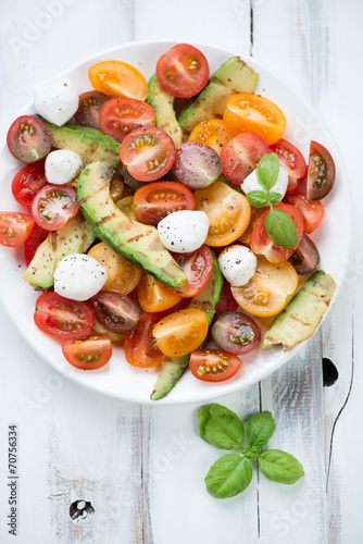 Vegetable salad with grilled avocado and mozzarella, above view