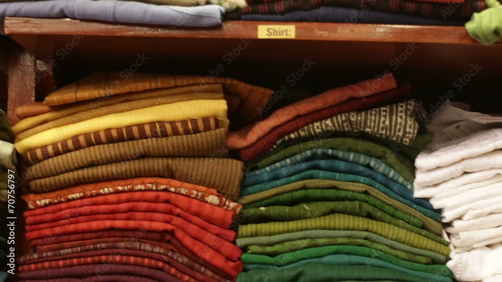 clothes hanging and lying on the shelves in the store clothes hanging and lying on the shelves in the store