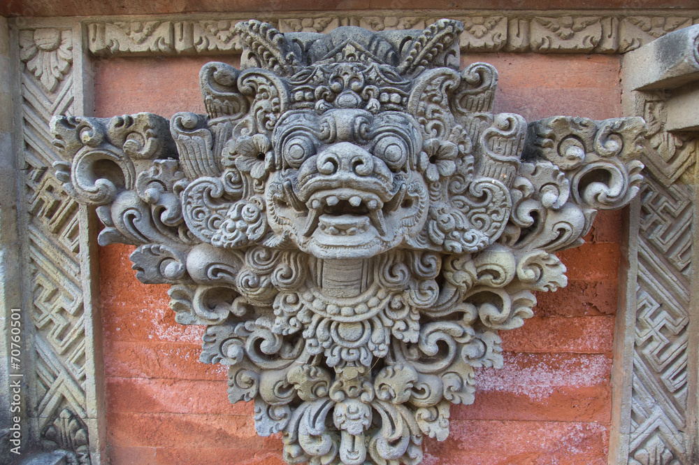 Stone sculpture decorating a temple wall, Bali island