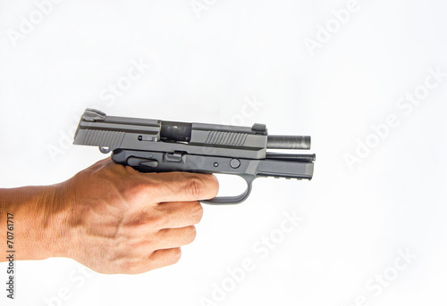 A hand holding a semi automatic handgun that is in ready