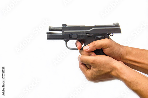 A hand holding a semi automatic handgun that is in ready