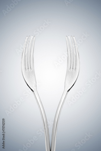 Artistic cup of wine form or hands form made with two forks.