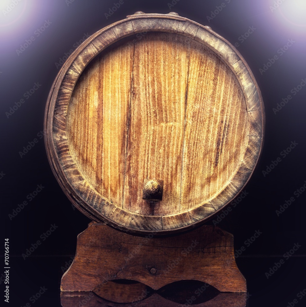 Fototapeta premium Old wooden barrel isolated on dark background.