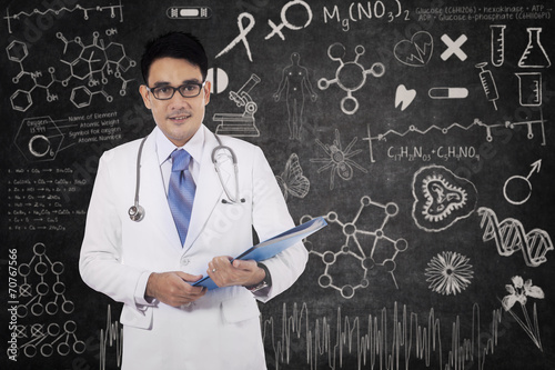 Doctor with doodle on the blackboard