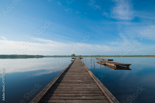 Wooden pier in a lake. Sunrise at Soustons, France