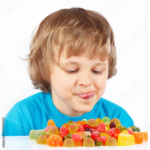 Little child looking at colored jelly candies