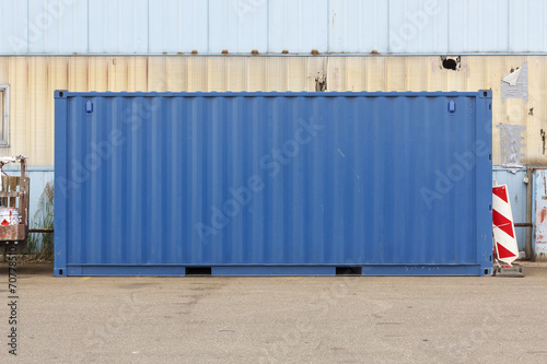 Unmarked blue shipping container.