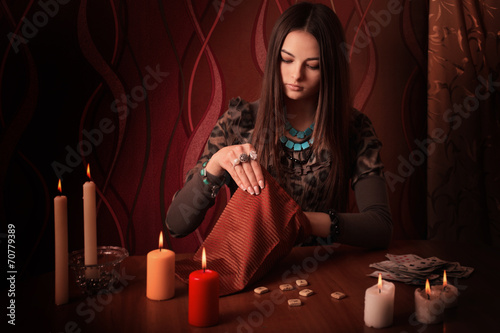 Canvas-taulu Young woman with runes and divination cards in room