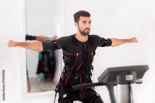 man working on electro muscular stimulation machine