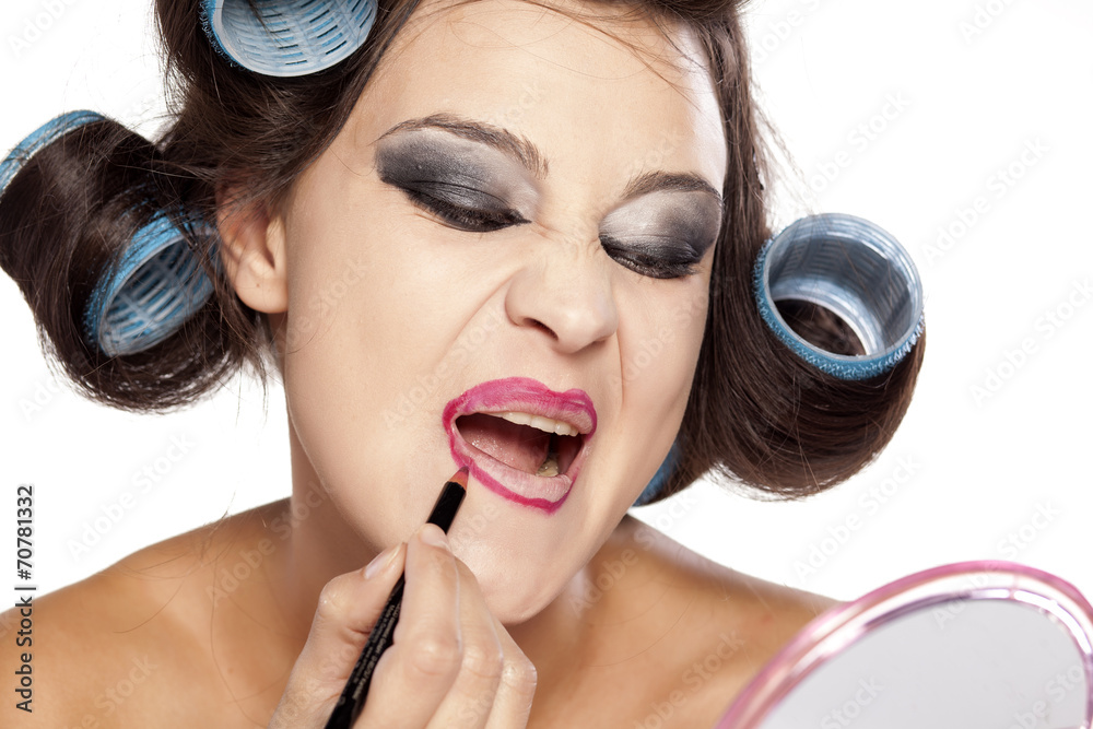 Funny woman with curlers and bad makeup applied lip pencil Stock Photo |  Adobe Stock