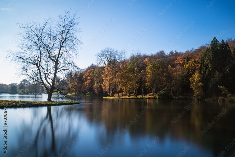 Beautiful landscape of Autumn trees and colors reflected in lake Beautiful landscape of Autumn trees and colors reflected in lake