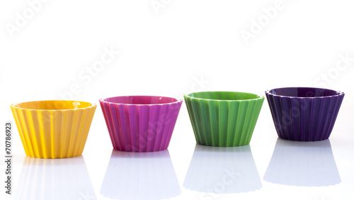 Colorful cups over white background