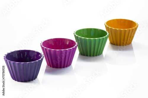 Four colorful cups over white background