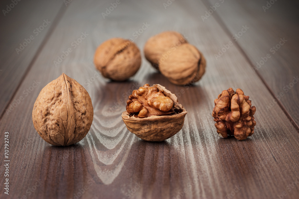 walnuts on the brown wooden table walnuts on the brown wooden table