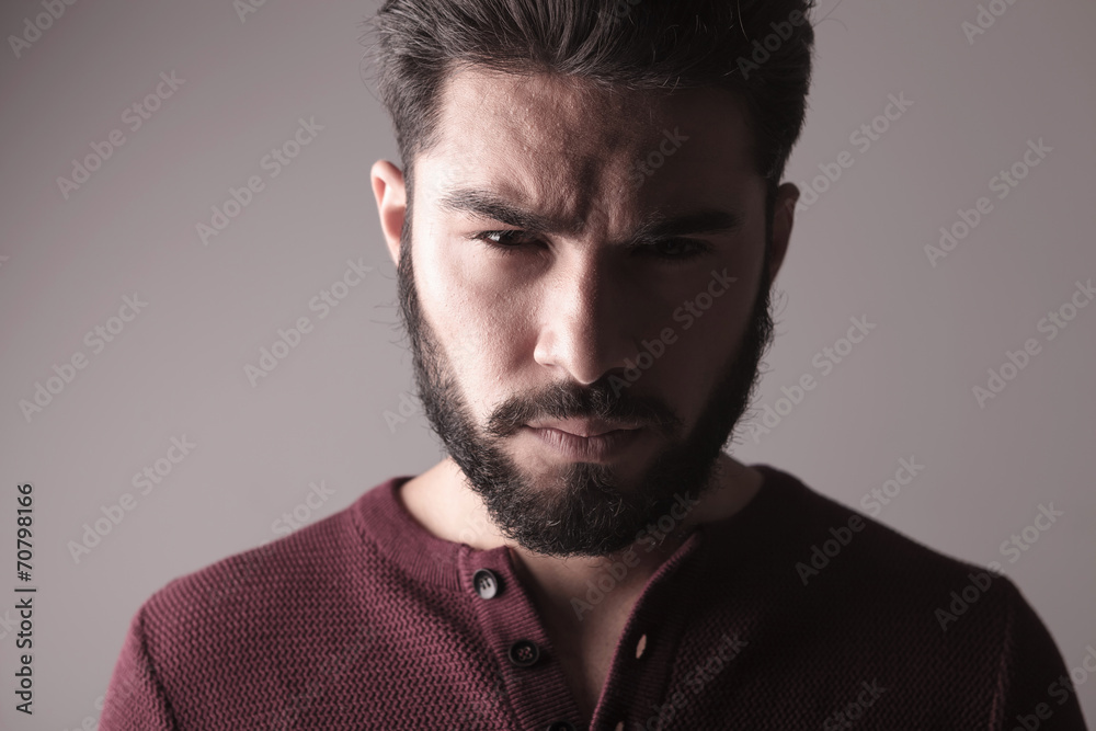 man wearing a sweater and looking at the camera