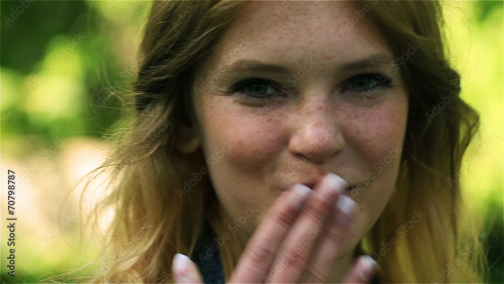 Girl sending sweet kiss and smiling to the camera, steadycam Girl sending sweet kiss and smiling to the camera, steadycam