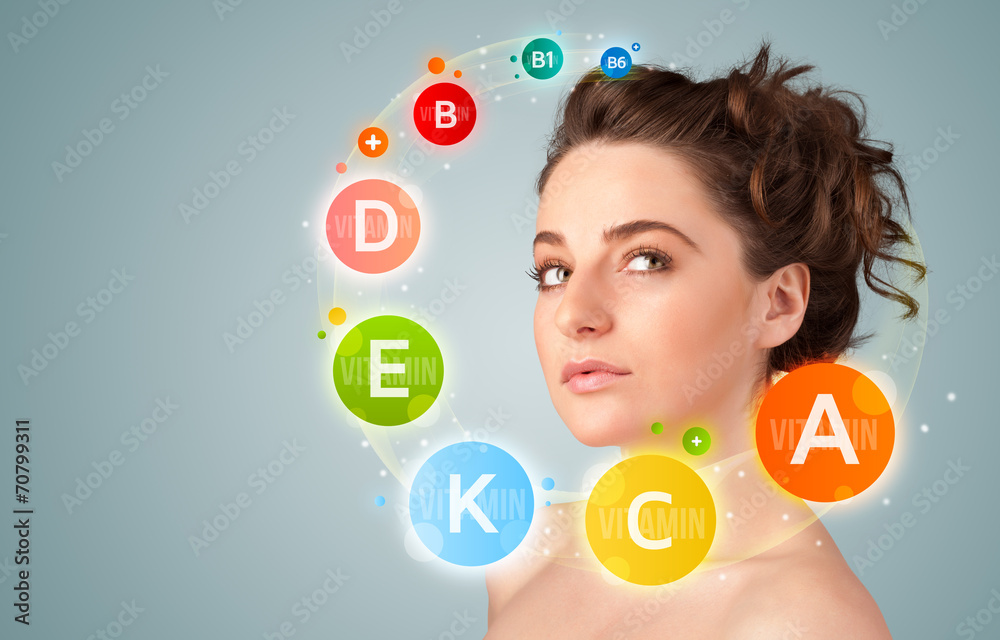 Pretty young girl with colorful vitamin icons and symbols Pretty young girl with colorful vitamin icons and symbols