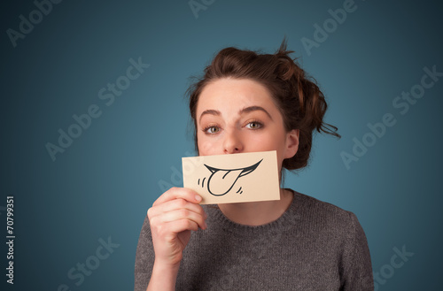 Pretty young girl holding white card with smile drawing